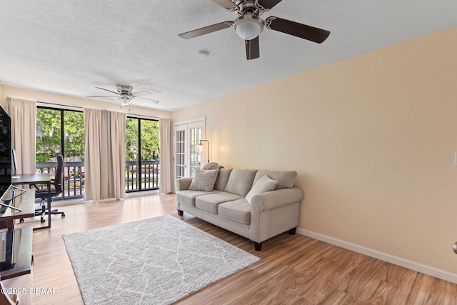 208 Pine Cone Trl, Ormond Beach, FL 32174 - living room with ceiling fan, wood finished floors, baseboards, and a textured ceiling