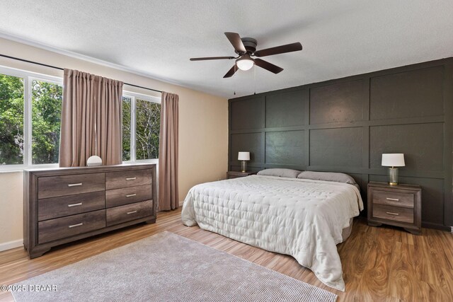 208 Pine Cone Trl, Ormond Beach, FL 32174 - bedroom featuring wood finished floors, a decorative wall, ceiling fan, and baseboards