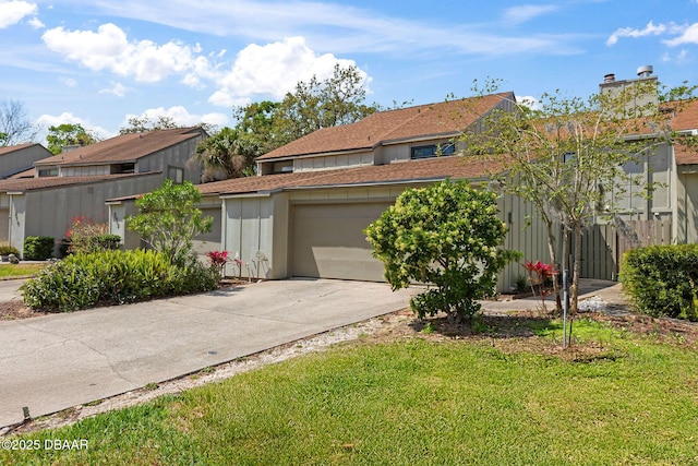 208 Pine Cone Trl, Ormond Beach, FL 32174 - view of front of home with driveway, an attached garage, and roof with shingles