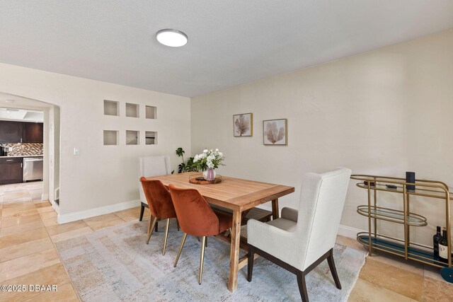 208 Pine Cone Trl, Ormond Beach, FL 32174 - dining area featuring light tile patterned floors and baseboards