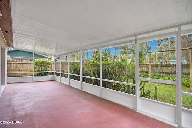 unfurnished sunroom with lofted ceiling