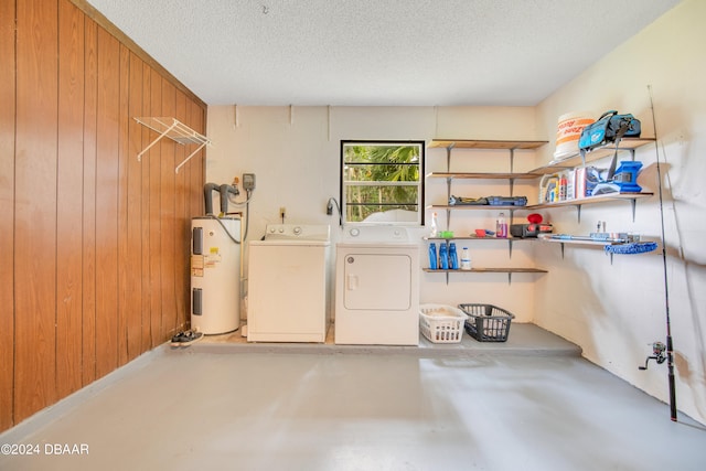 laundry room with independent washer and dryer, a textured ceiling, wooden walls, and water heater