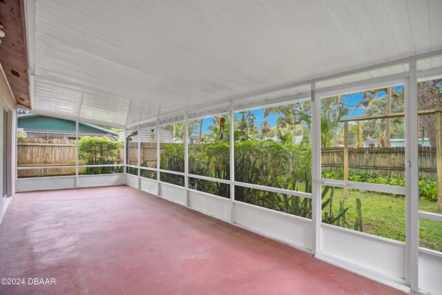 unfurnished sunroom featuring lofted ceiling