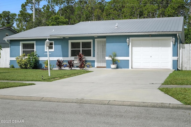 1720 Hope Dr, Ormond Beach, FL 32174 - view of front of home with an attached garage, stucco siding, driveway, and a metal roof