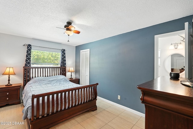1720 Hope Dr, Ormond Beach, FL 32174 - bedroom featuring a closet, a textured ceiling, a ceiling fan, and light tile patterned floors