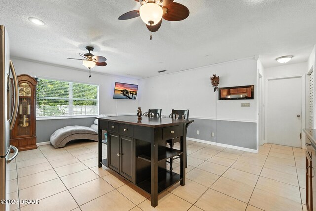 1720 Hope Dr, Ormond Beach, FL 32174 - dining area with a textured ceiling, ceiling fan, and light tile patterned floors