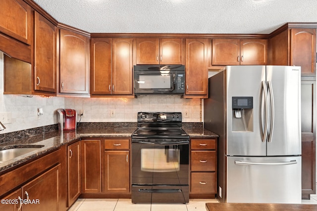1720 Hope Dr, Ormond Beach, FL 32174 - kitchen featuring black appliances, a textured ceiling, dark stone countertops, and decorative backsplash