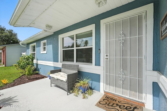 1720 Hope Dr, Ormond Beach, FL 32174 - property entrance with stucco siding and a porch
