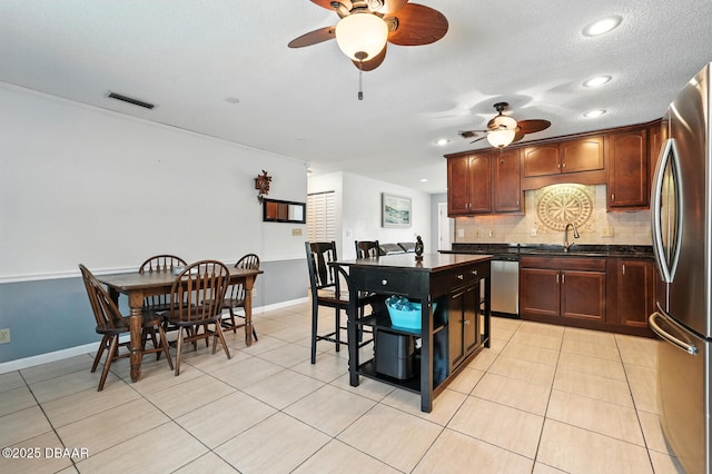 1720 Hope Dr, Ormond Beach, FL 32174 - kitchen featuring dark countertops, stainless steel appliances, ceiling fan, backsplash, and recessed lighting