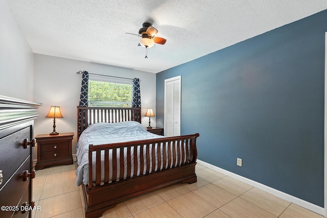 1720 Hope Dr, Ormond Beach, FL 32174 - bedroom featuring a closet, a textured ceiling, light tile patterned floors, and ceiling fan