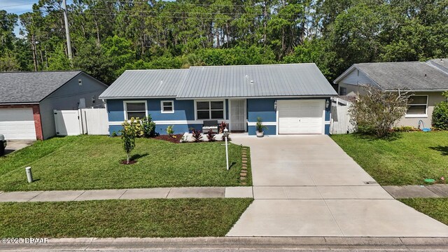 1720 Hope Dr, Ormond Beach, FL 32174 - single story home featuring an attached garage, concrete driveway, stucco siding, a metal roof, and a gate