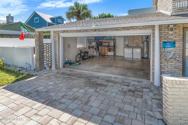 view of patio / terrace with washing machine and dryer and water heater