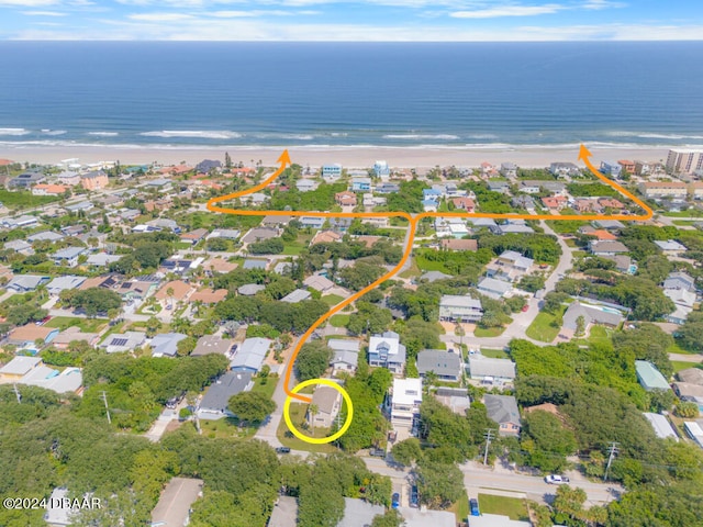 bird's eye view featuring a water view and a view of the beach