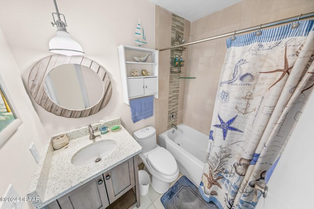 full bathroom with vanity, shower / tub combo with curtain, tile patterned floors, and toilet