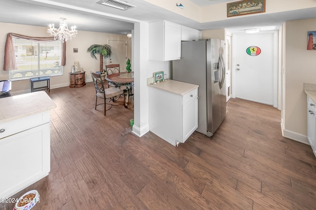 kitchen featuring stainless steel refrigerator with ice dispenser, dark hardwood / wood-style floors, decorative light fixtures, a notable chandelier, and white cabinets