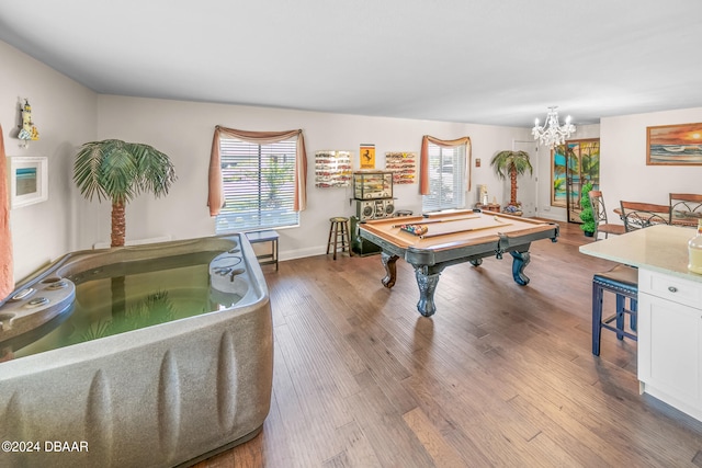 rec room with an inviting chandelier, light hardwood / wood-style floors, and billiards