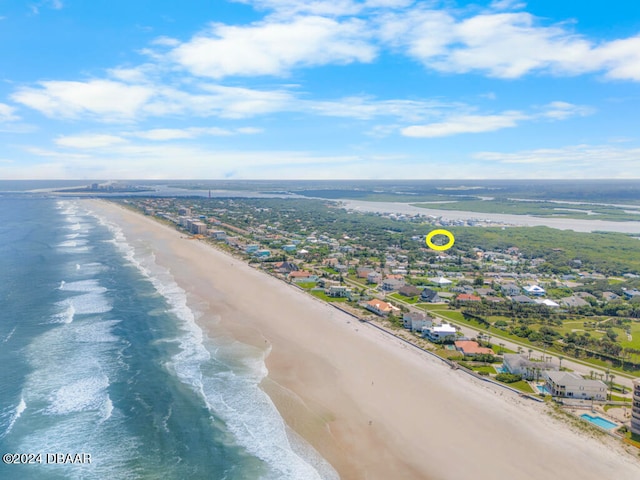 drone / aerial view featuring a water view and a view of the beach