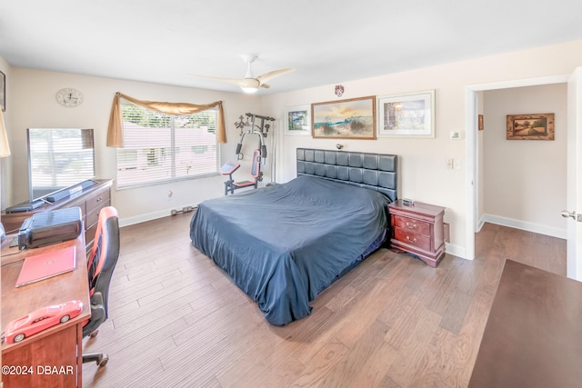 bedroom with hardwood / wood-style floors and ceiling fan