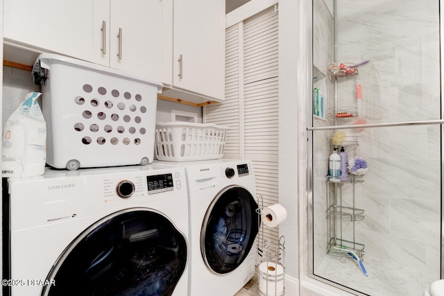 laundry area with cabinets and washing machine and dryer