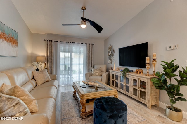 living room featuring ceiling fan, light wood-type flooring, and vaulted ceiling