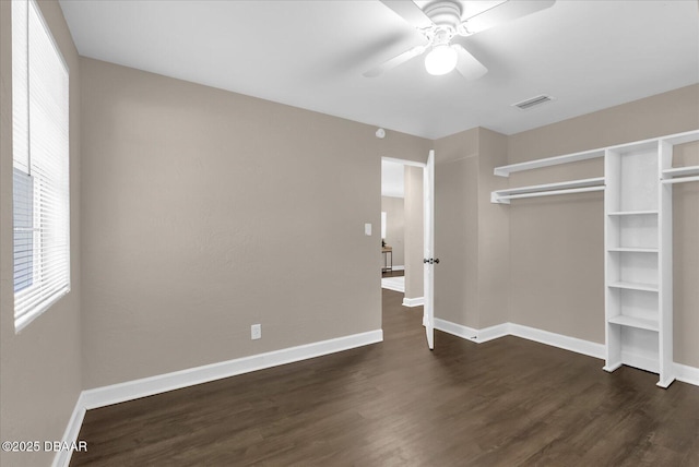 461 Brentwood Dr, Daytona Beach, FL 32117 - unfurnished bedroom with dark wood finished floors, a closet, and a ceiling fan