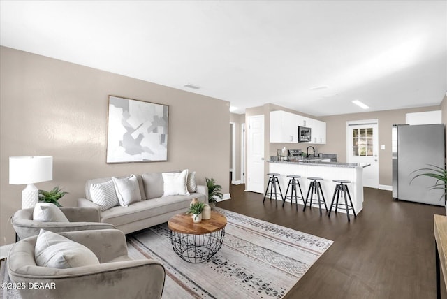 461 Brentwood Dr, Daytona Beach, FL 32117 - living area featuring dark wood-style flooring and baseboards