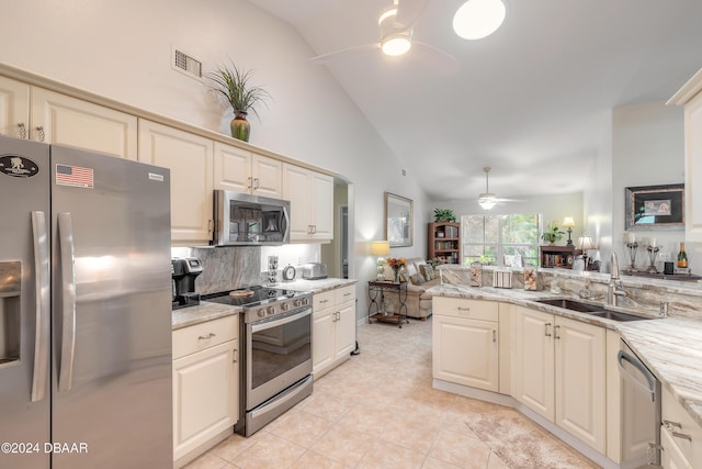 5452 Saint Regis Way, Port Orange, FL 32128 - kitchen featuring stainless steel appliances, ceiling fan, open floor plan, decorative backsplash, and light tile patterned flooring