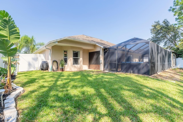 5452 Saint Regis Way, Port Orange, FL 32128 - rear view of house with a fenced backyard, stucco siding, a gate, and glass enclosure