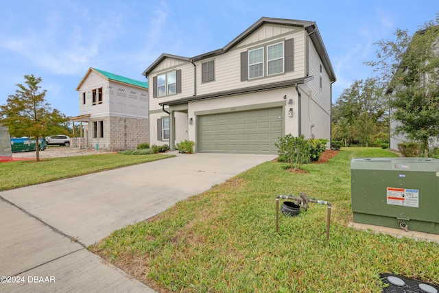 view of front of home with a garage and a front lawn