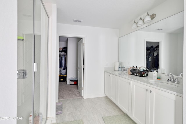 bathroom with walk in shower and vanity