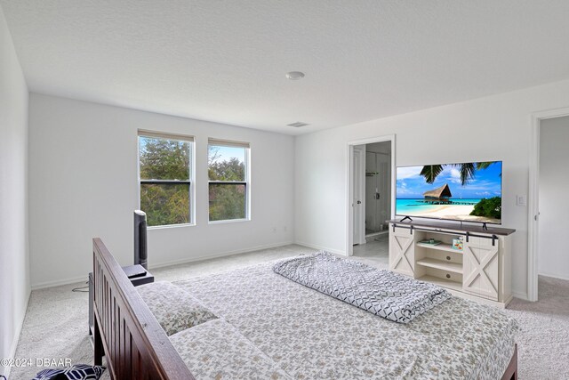 carpeted bedroom featuring a textured ceiling