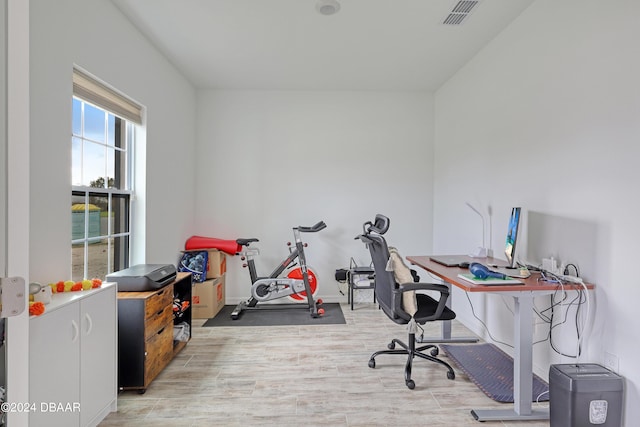 home office with light hardwood / wood-style flooring