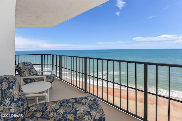 balcony with a view of the beach and a water view