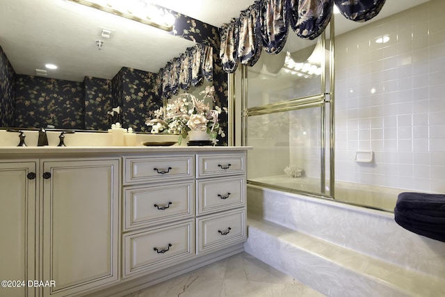 2425 S Atlantic Ave Unit 1403, Daytona Beach, FL 32118 - bathroom with wallpapered walls, marble finish floors, combined bath / shower with glass door, and double vanity