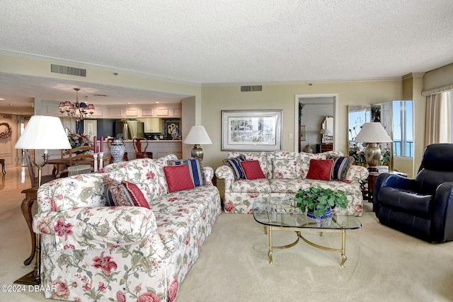 carpeted living room with ornamental molding, a textured ceiling, and a notable chandelier