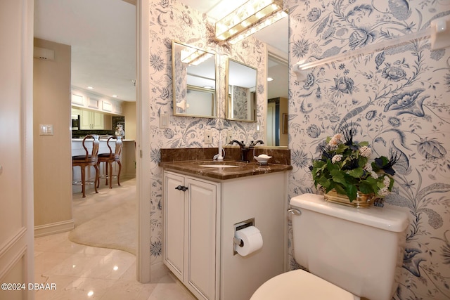 bathroom with vanity and toilet