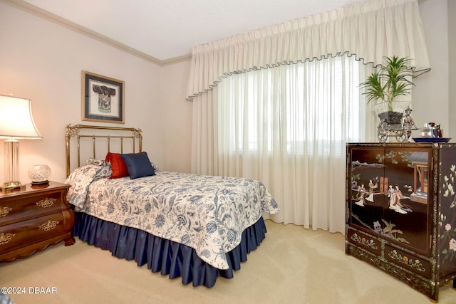 bedroom with carpet floors, a textured ceiling, and crown molding