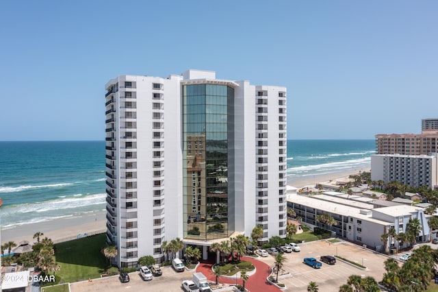 view of property with a beach view and a water view