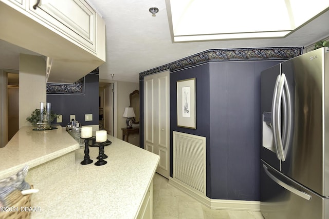 2425 S Atlantic Ave Unit 1403, Daytona Beach, FL 32118 - kitchen with stainless steel refrigerator with ice dispenser and light countertops