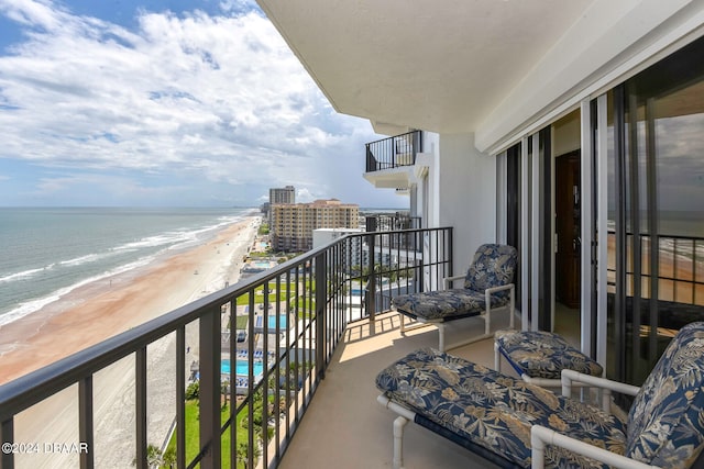 balcony with a beach view and a water view