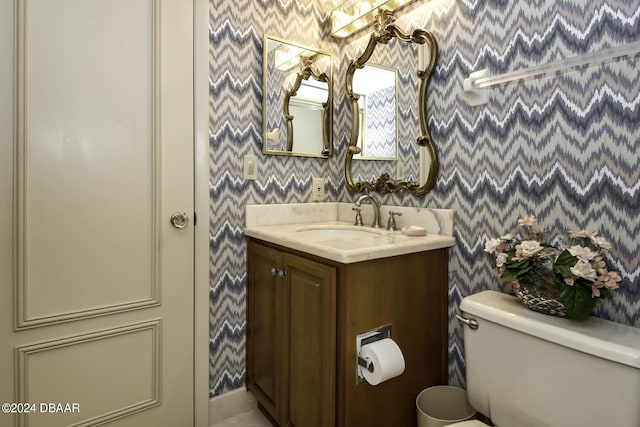 2425 S Atlantic Ave Unit 1403, Daytona Beach, FL 32118 - bathroom with wallpapered walls, toilet, and vanity