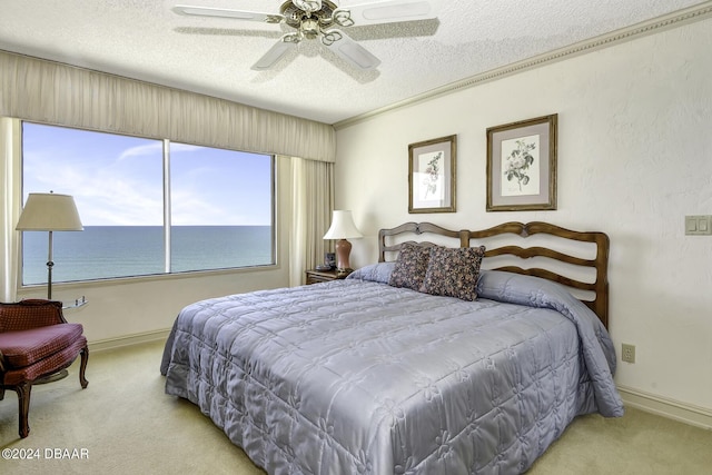 2425 S Atlantic Ave Unit 1403, Daytona Beach, FL 32118 - bedroom with carpet floors, a textured ceiling, baseboards, a ceiling fan, and a water view