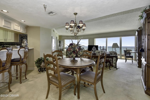 2425 S Atlantic Ave Unit 1403, Daytona Beach, FL 32118 - dining space featuring light carpet, a chandelier, baseboards, a water view, and recessed lighting