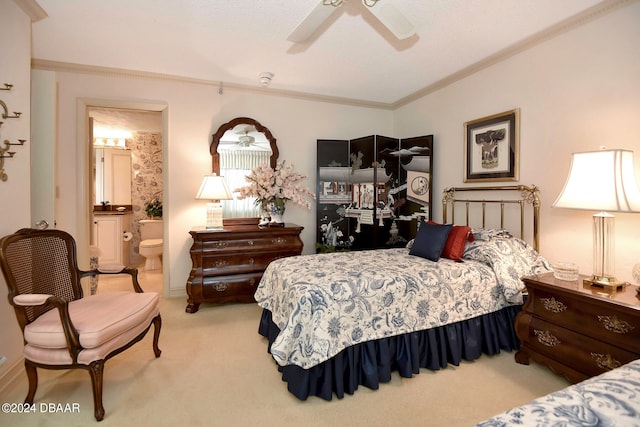 bedroom featuring ensuite bathroom, ceiling fan, a textured ceiling, crown molding, and light colored carpet