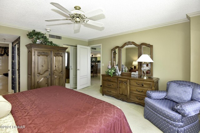 2425 S Atlantic Ave Unit 1403, Daytona Beach, FL 32118 - bedroom with ornamental molding, light carpet, a textured ceiling, and a ceiling fan