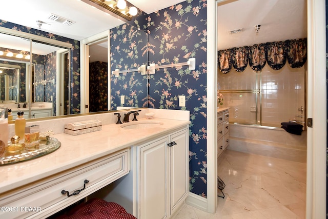 bathroom featuring vanity and tiled shower / bath