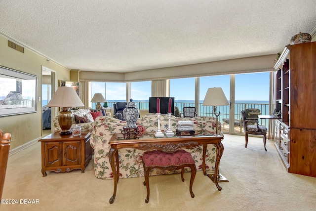 living room featuring light colored carpet, a textured ceiling, a water view, and crown molding