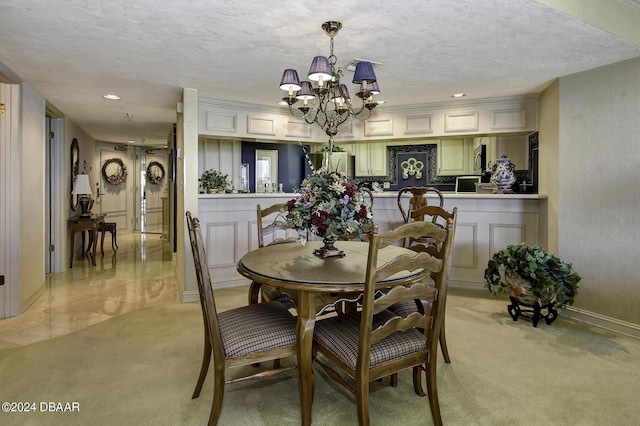 2425 S Atlantic Ave Unit 1403, Daytona Beach, FL 32118 - dining area with light colored carpet, a chandelier, a textured ceiling, recessed lighting, and baseboards