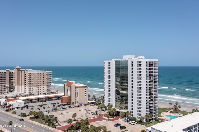 birds eye view of property featuring a beach view and a water view