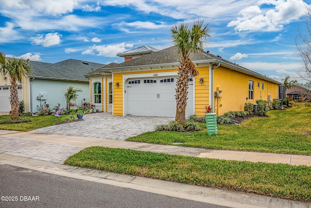 view of front of home featuring a front yard and a garage